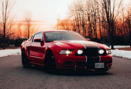 Mustang Auto - Red Sports Car on the Asphalt Road During Sunset