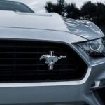 Mustang Auto - Close Up Photo of a Silver Ford Mustang